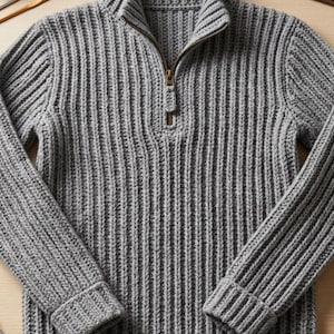 May include: A grey long-sleeve sweater featuring a vertical ribbed knit pattern, a high collar, and a metal zipper closure at the neckline. The garment has cuffed sleeves and a ribbed hem, showcasing a consistent texture throughout the entire piece.
