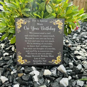 May include: A square dark grey memorial plaque featuring yellow floral illustrations in the corners and white text that reads: For A Special Mum On Your Birthday, followed by a sentimental poem and the names Samantha, Neil & Charlie xxx.