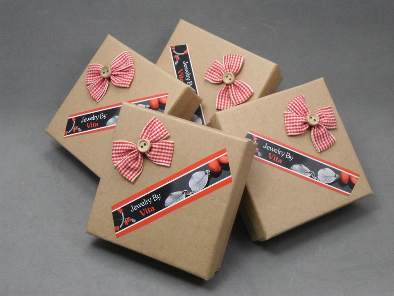 May include: Five brown cardboard boxes with red and white gingham bows and a label that reads "Jewelry By Vita".