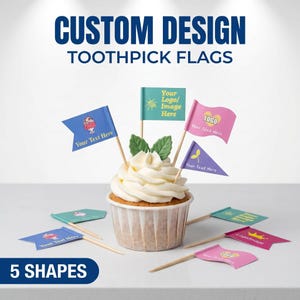 May include: Custom design toothpick flags featuring various colours and shapes, including blue, teal, pink, and purple, with printed text and logos. Several flags are inserted into a cupcake with white frosting, while others lie flat on the surface.
