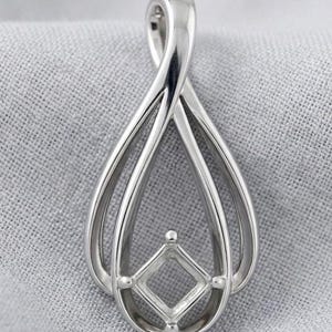 May include: A polished silver-toned metal pendant featuring a teardrop-shaped frame with a twisted top loop. Centered within the lower portion of the teardrop is a square-shaped setting with four small prongs, designed to hold a single gemstone.