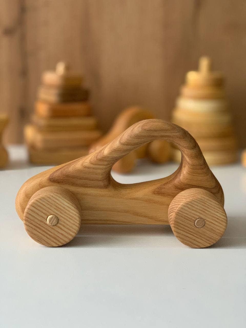 close up of wooden toy car showing wood grain non toxic label sustainable wood