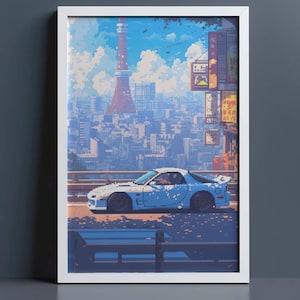 May include: A framed pixel art print featuring a light blue sports car parked on a city street. In the background, a tall red and white tower rises above a dense urban skyline under a bright blue sky with white clouds and Japanese signage.