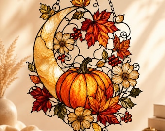 May include: A stained glass suncatcher featuring a crescent moon, a central orange pumpkin, red and orange maple leaves, white flowers, and clusters of red berries. The design is framed by black metal lines and hangs from a black metal chain.