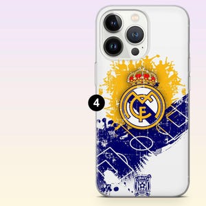 May include: A clear smartphone case featuring a Real Madrid soccer club logo with a crown, a yellow sunburst graphic, and a blue diagonal soccer field pattern. The design includes a small logo at the bottom with the text LIGRAFICA and a number 4.