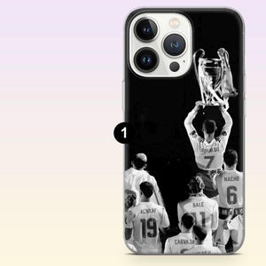 May include: A black and white phone case featuring a group of soccer players in jerseys with names and numbers including Ronaldo 7, Bale 11, Nacho 6, Achraf 19, and Carvajal. The players are shown from behind, with one player lifting a large trophy.