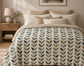 May include: A bedding set featuring a duvet cover with a repeating vertical pattern of stylized leaves in shades of dark green, olive, and muted blue on an off-white background, accompanied by several beige and cream-colored decorative pillows.