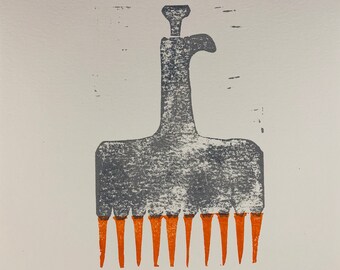 May include: A gray and orange comb with a handle and ten teeth. The comb is made of wood and has a rustic look.