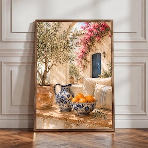 Könnte beinhalten: Ein gerahmter Wandkunstdruck, der einen mediterranen Innenhof zeigt, mit einem Olivenbaum in einem Terrakottatopf, einem blau-weiß gemusterten Keramikkrug und einer passenden Schale voller leuchtend orangefarbener Zitrusfrüchte auf einem Steinsims.