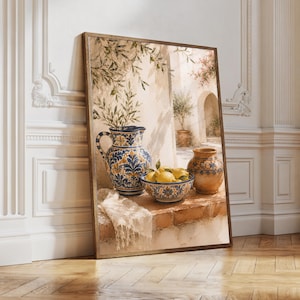 May include: A framed wall art print depicting a Mediterranean scene with a blue and yellow patterned ceramic pitcher, a matching bowl filled with yellow lemons, and a plain terracotta vase resting on a stone ledge with a white cloth.