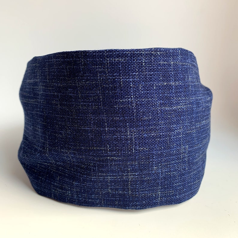 May include: A dark blue fabric headband with a textured woven pattern.