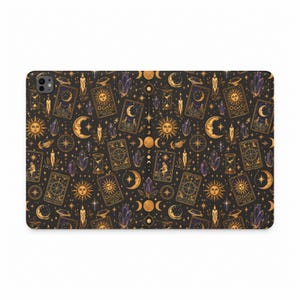 May include: A rectangular tablet case featuring a dark black background with a repeating pattern of gold-toned tarot cards, suns, crescent moons, hourglasses, lit candles, and purple crystals. The design includes celestial motifs and stars.