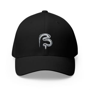 May include: A black baseball cap featuring a white embroidered graphic of a coiled snake on the front center. The cap has a structured crown, a curved brim, and a button at the top. The embroidery depicts a snake in a vertical, winding position.