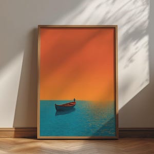 Pode incluir: Uma impressão de arte emoldurada apresentando um pequeno barco flutuando em águas azuis calmas sob um céu laranja sólido. O barco está posicionado na parte inferior central da composição, criando um contraste entre as cores laranja e azul.