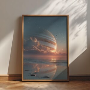 May include: A framed wall art print featuring a surreal landscape where a large, striped gas giant planet hangs low in the sky above a calm ocean. Soft clouds drift near the horizon, reflecting in the wet sand of the beach under a starry night.