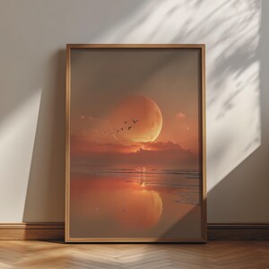 May include: A rectangular wall art print in a light wood frame featuring a sunset landscape with a large orange moon, a calm ocean reflecting the light, and a small flock of birds flying across the sky in a warm, monochromatic colour palette.