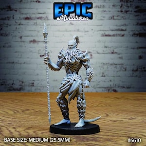 May include: A light gray unpainted miniature figure of a humanoid creature with a tentacled face, muscular build, and textured armor, holding a tall, slender spear. The figure stands on a round black base with text indicating a 25.5mm medium base size.