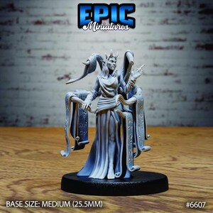 May include: A grey resin miniature figure of a humanoid character with horns, wearing a long flowing robe. The figure is surrounded by multiple floating scrolls inscribed with symbols, standing on a circular black base with a 25.5mm diameter.