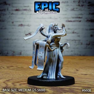 May include: A light gray miniature figurine of a humanoid figure with horns, wearing a long flowing robe. The figure is surrounded by floating scrolls with etched symbols. The miniature stands on a round black base, labeled Base Size: Medium (25.5mm).