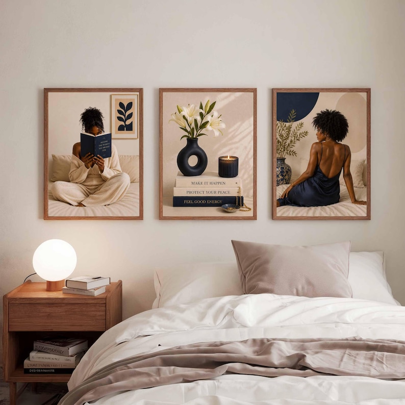 May include: Three framed wall art prints displayed above a bed. The left print shows a person reading a book. The center print features white lilies in a black vase on stacked books with text. The right print depicts a person in a dark dress.