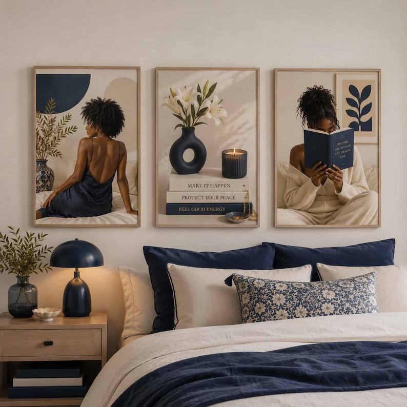 May include: A set of three framed wall art prints featuring a person in a dark blue dress, a navy vase with white lilies and a candle on stacked books labeled Make It Happen, Protect Your Peace, Feel Good Energy, and a person reading a blue book.