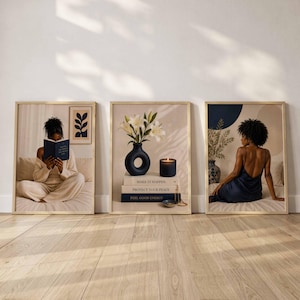 May include: Three framed wall art prints. The left shows a person in beige loungewear reading a book. The center features a dark blue vase with white lilies, a candle, and books labeled Make It Happen, Protect Your Peace, and Feel Good Energy. The right shows a person in a dark blue dress.