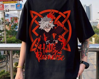 May include: A black short-sleeved t-shirt featuring a graphic print of an anime character with white hair surrounded by red flames and a geometric pattern. The text Hell's Paradise is printed in a stylised red font below the character illustration.
