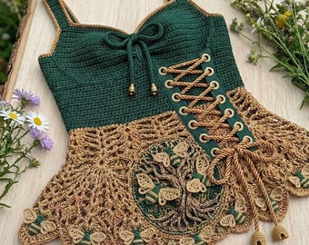 May include: A dark green crochet tank top featuring a tan lace-up corset front with gold-toned eyelets and a decorative tan crochet peplum hem. The lower section displays an intricate tree motif surrounded by several small, detailed bee appliques.