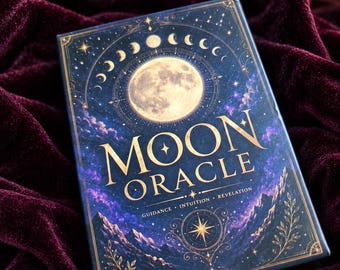 May include: A rectangular Moon Oracle deck box featuring a full moon, lunar phases, and mountain landscape illustrations in gold and blue. The text reads MOON ORACLE, GUIDANCE, INTUITION, REVELATION. The design includes celestial stars and botanical accents.