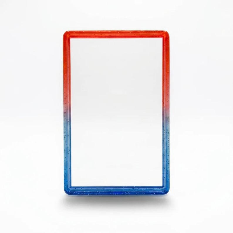 May include: A rectangular frame with a smooth, glossy finish featuring a gradient color transition from vibrant red at the top to deep blue at the bottom. The frame is embedded with fine, subtle glitter particles throughout the material.