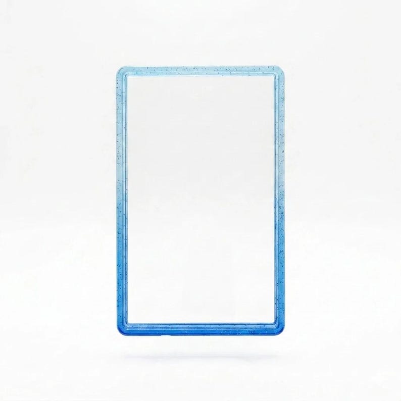 May include: A rectangular frame with a clear center and a blue border featuring a subtle glittery finish. The frame has a smooth, raised edge and a consistent thickness throughout, creating a simple, clean, and open rectangular structure.