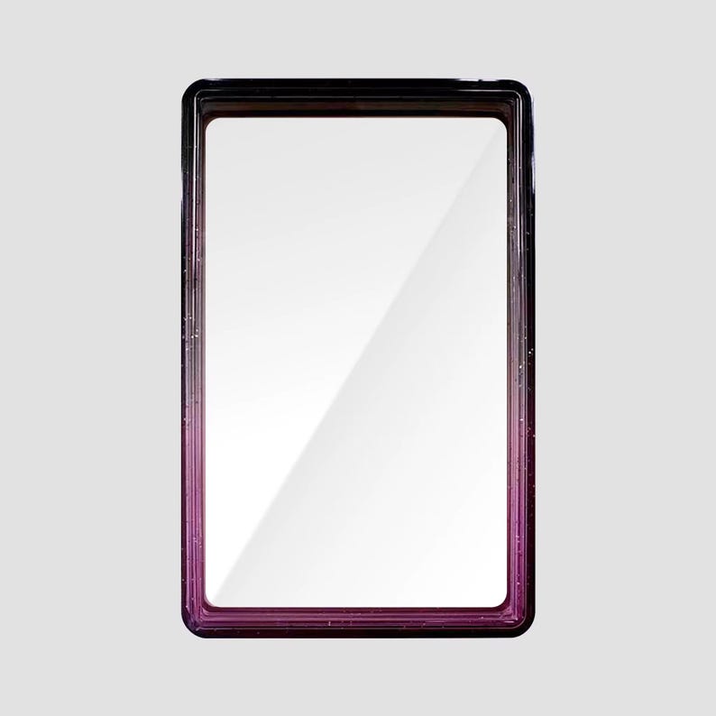 May include: A rectangular display case with a clear front panel and a frame that transitions from a deep black at the top to a vibrant purple at the bottom. The frame features a subtle glittery texture throughout its dark and purple surface.