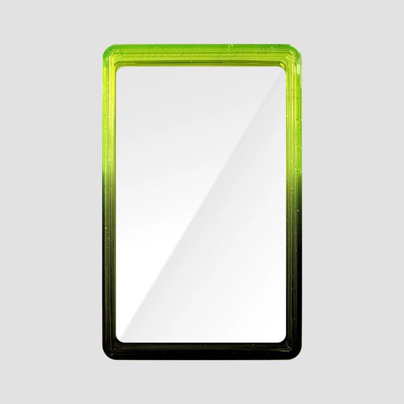 May include: A rectangular mirror featuring a frame with a gradient color transition from bright lime green at the top to deep black at the bottom. The frame has a smooth, glossy finish with subtle embedded glitter particles throughout the material.