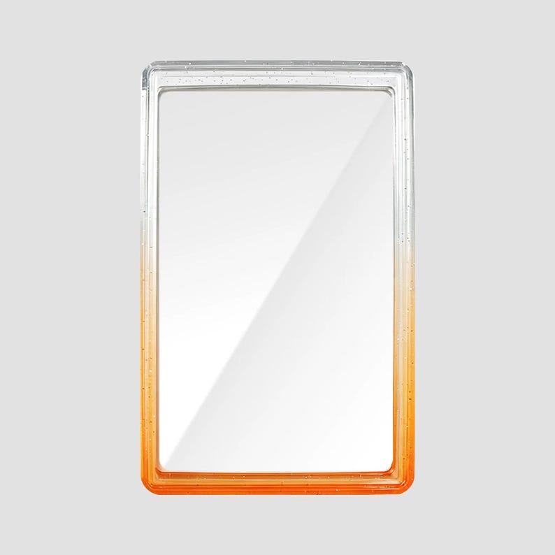 May include: A rectangular, clear acrylic frame featuring a smooth color gradient that transitions from a transparent top to a vibrant orange base. The frame has a thick, polished border with a glossy finish, designed to hold a single photograph.