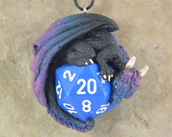 May include: A small, black and purple dragon figurine curled around a blue 20-sided die.