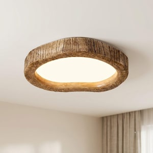 May include: A flush mount ceiling light fixture featuring a circular frame with a textured, brown wood grain finish. The center of the fixture contains a smooth, opaque white panel that emits a soft, diffused light across the room.