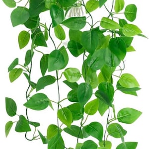 May include: A hanging artificial plant featuring multiple cascading vines with vibrant green, heart-shaped leaves. The foliage is dense at the top and thins out toward the bottom, with thin, flexible stems connecting each individual leaf.