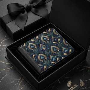 May include: A bi-fold wallet featuring a dark blue and gold peacock feather pattern, presented inside a black gift box with a matching lid and black ribbon. A small black card with gold text reading UNWRAP THE EXTRAORDINARY is included.