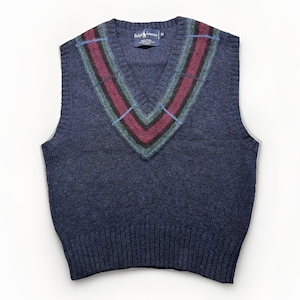 May include: A navy blue V-neck sweater vest featuring a ribbed hem and neckline. The neckline is accented with a striped pattern in shades of burgundy, dark green, and light blue. A Ralph Lauren brand label is visible at the inner collar area.