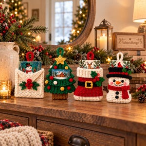 May include: Four crocheted Christmas gift card holders shaped like an envelope, a tree, a stocking, and a snowman. Each holder features a small festive card, vibrant yarn colors, and intricate details like holly berries, a star, and a belt.