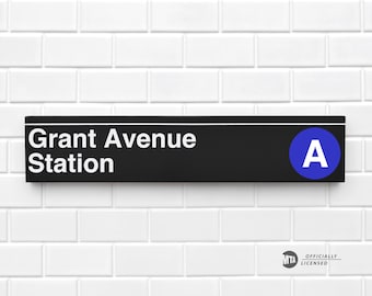 May include: Black and white sign with white text that reads "Grant Avenue Station" and a blue circle with a white "A" in the upper right corner. The sign is mounted on a white tiled wall. The MTA logo is in the lower right corner.