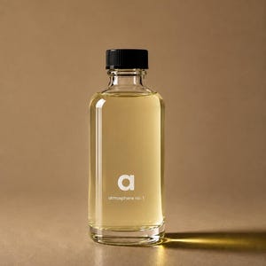 May include: A clear glass bottle filled with a pale yellow liquid, featuring a black screw-top cap. The front of the bottle displays the white lowercase letter a and the text atmosphere no. 1 printed in a clean, sans-serif font style.