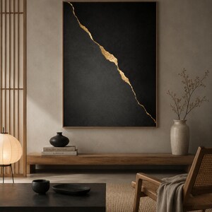 Könnte beinhalten: Ein rechteckiges Wandbild mit einer texturierten schwarzen Oberfläche, die diagonal von einer gezackten, schimmernden goldenen Linie geteilt wird. Das Kunstwerk ist in einen dünnen, dunklen Holzrahmen gefasst, der einen starken Kontrast erzeugt.