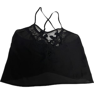 May include: A black sleeveless camisole top featuring a sheer, lightweight fabric body and a decorative lace panel across the upper chest. The garment includes thin, adjustable spaghetti straps that cross over each other at the upper back area.