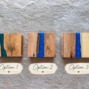 May include: Three rectangular wooden blocks with resin inlays, labeled Option 1, Option 2, and Option 3. Option 1 features a dark green resin strip, while Options 2 and 3 contain bright blue resin strips between natural wood grain sections.