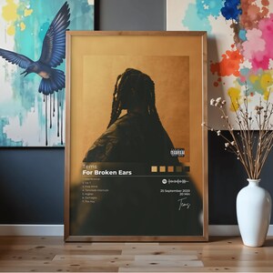 May include: A framed rectangular poster featuring the album cover for Tems For Broken Ears. The artwork displays a silhouette of a person with braided hair against a gold background, tracklist, Spotify code, and a Parental Advisory label.