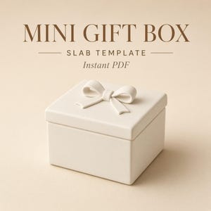 May include: A cream-colored square gift box with a matching bow on the lid. The text above the box reads MINI GIFT BOX SLAB TEMPLATE Instant PDF. The box has a smooth, matte finish and a clean, simple design with a removable lid and base.