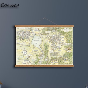 May include: A hanging canvas wall art piece featuring a detailed illustrated map titled Map of Beatrix Potter's World. The map displays various landscapes, paths, and locations in muted green, yellow, and brown tones, secured by wooden rails.