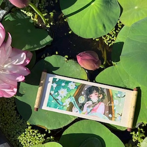 May include: A rectangular wall scroll featuring a colourful anime-style illustration of a person with dark hair surrounded by white flowers and green foliage, with wooden dowels at the top and bottom ends of the paper print.