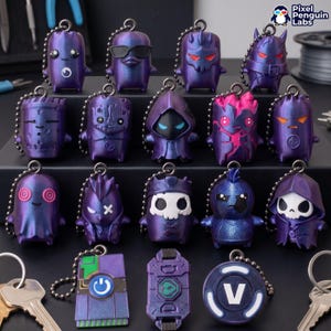 May include: A collection of purple 3D printed keychains featuring various character designs, including skulls, hooded figures, and geometric shapes. Each keychain has a metal ball chain attached. Some items display symbols like a power button or the letter V.